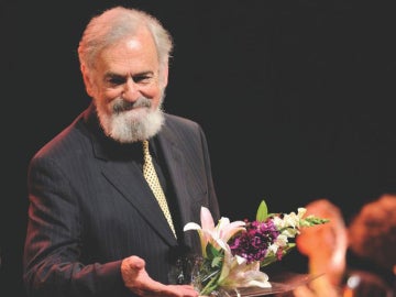 a photo of a professor receiving flowers after a performance