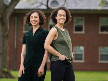 two people stand on Oberlin's campus smiling
