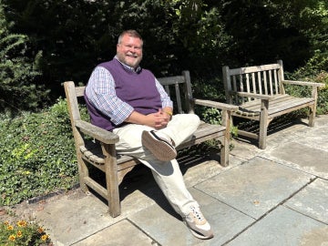 Chris Jorgenson seated on a park bench.