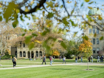 students walking across campus on a fall day.