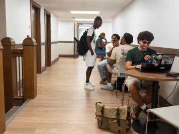 students studying and visiting in a Wilder Hall social space.