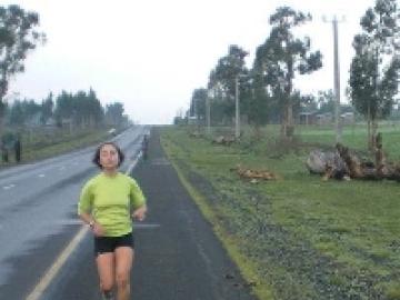 Joanna Johnson ’11 running along an asphalt path.