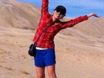 The author posing for a photo in a desert