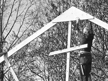 Man rebuilding the steeple of a church