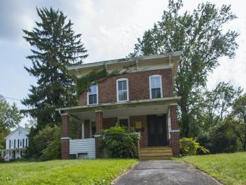 Front exterior view of two-story red brick house built in 1850s