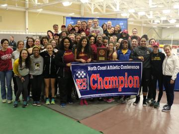 The team shows off their championship banner.
