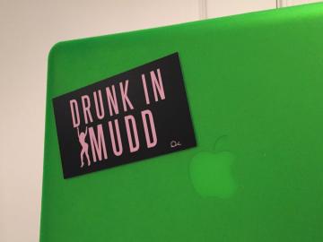 Sticker on a computer says 'Drunk in Mudd'