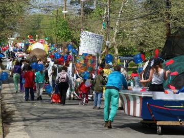 Parade participants march down the street.