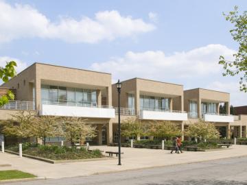 Two people walking in front of Stevenson Hall 