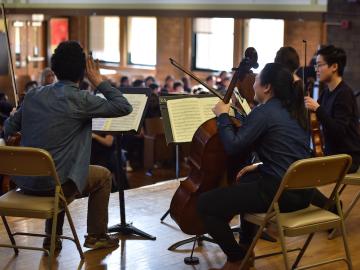 string ensemble musicians performing for children.