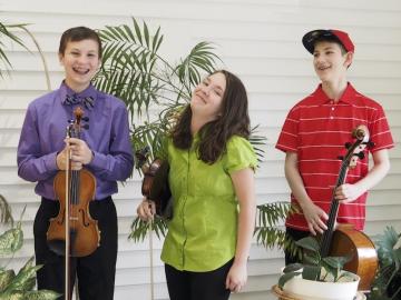three children with string instruments.