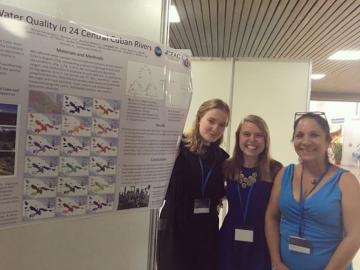 From left: Monica Dix ’20, Mae Kate Campbell ’17,  Rita Sibello Hernandez in front of research poster