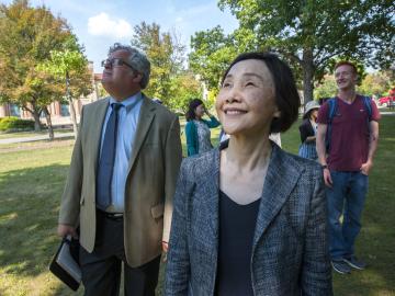 Tomoko Watanabe walks with Gavin Tritt and others in Tappan Square