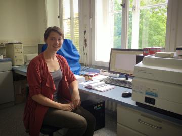 Emilie Lozier seated at a lab computer