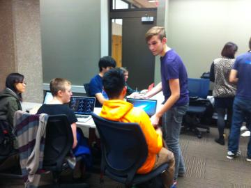 A COMETS student mentor with students in Mudd Library
