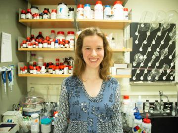 woman standing in chemistry lab.