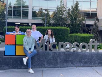 Jessica and 3 others at a Microsoft sign outside an office building.