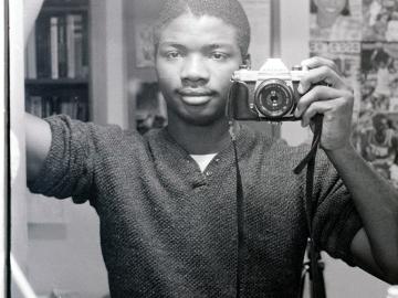 Self portrait in a mirror using a 35 mm camera (black & white).