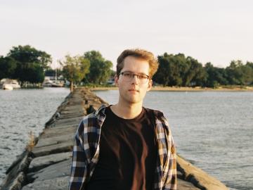 young man Josh Augustin standing on pier