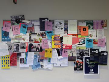 Picture of a board covered in posters