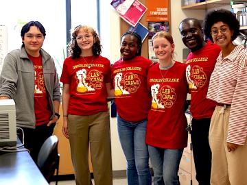 Student participants in Lab Crawl smiling with professor Gunnar Kwakye.