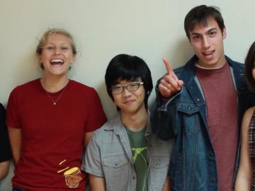 Five students laughing and smiling