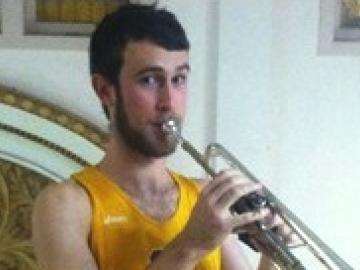 An athlete plays a trumpet