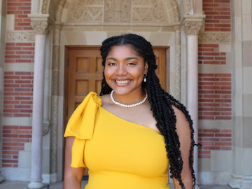 woman in yellow dress smiling.