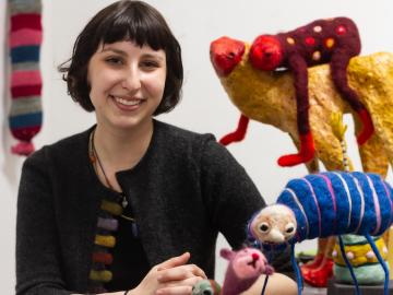 Headshot of Nina Josephson with her artwork