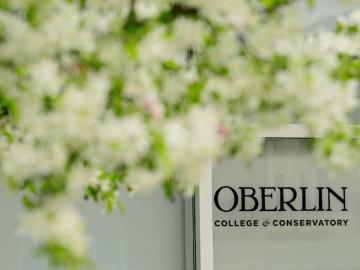 campus image of Oberlin College and Conservatory with blossoming tree framing an Oberlin logo.