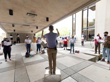 socially distanced student musicians rehearsing together.