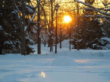 sun setting on winter snow scene.
