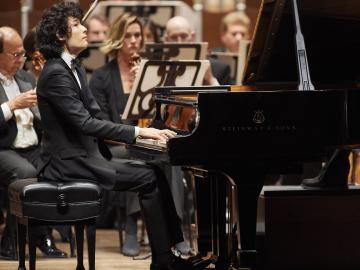 student musician playing the piano
