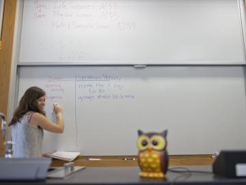 student writing on whiteboard