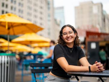 Women sits at table.