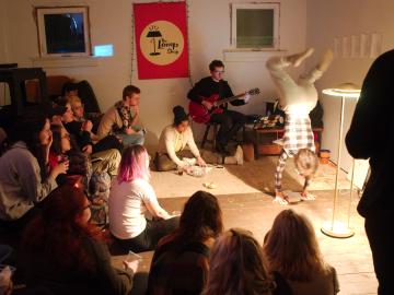 Students perform at an improvisational performance art show 