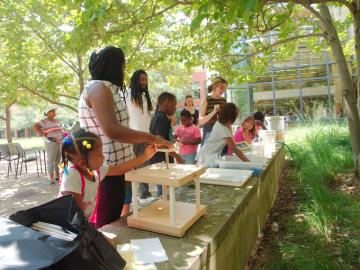 adults and children working together to build science projects