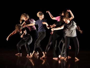 Six dancers perform contemporary group movement