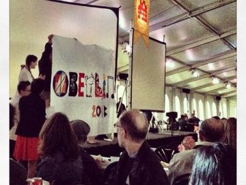 People hold up a homemade banner that reads 'Oberlin 2013'
