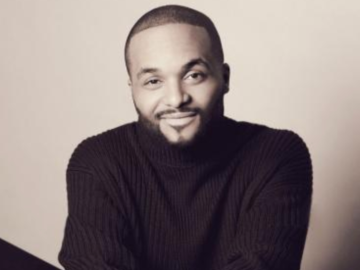man sitting and smiling at camera