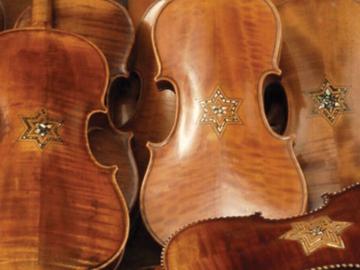 backs of Holocaust era violins with inlaid Stars of David on the backs