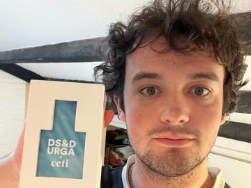 Student holds perfume.