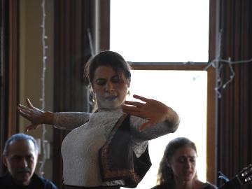 A woman looks intense with outstretched hands.