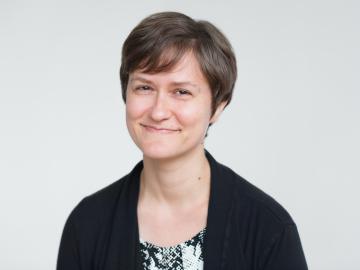 A portrait of a young teacher wearing a sweater.