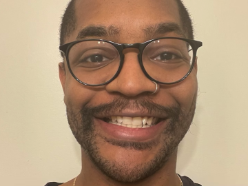 A portrait of a man wearing glasses.