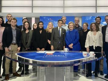 A group photo on the set of a CNN talk show.