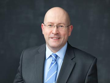 A portrait of a man in a suite.