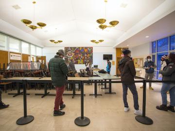 Students stand six feet apart in a line.