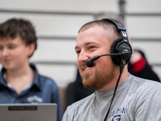 Colin Regan '22 working as the Sports Information Coordinator at Gilman School 