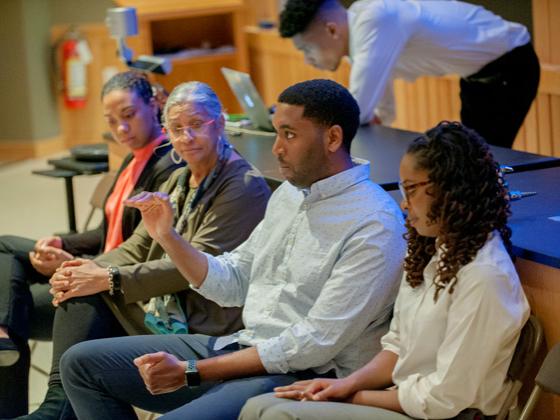 Students of color participating in a discussion.